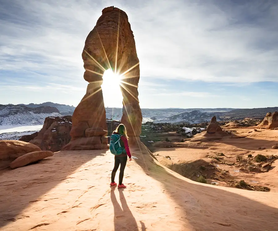 rear-view-woman-standing-by-rock-against-sky (2)
